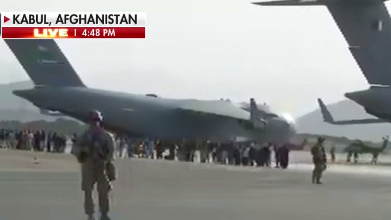 Hundreds of Afghans wait outside Kabul airport