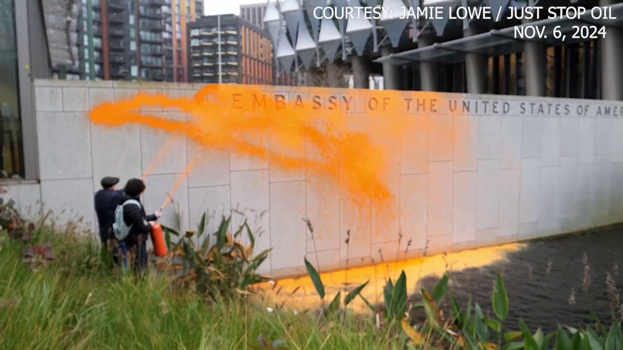 Climate activists cover US embassy in London with orange paint after Trump's projected win