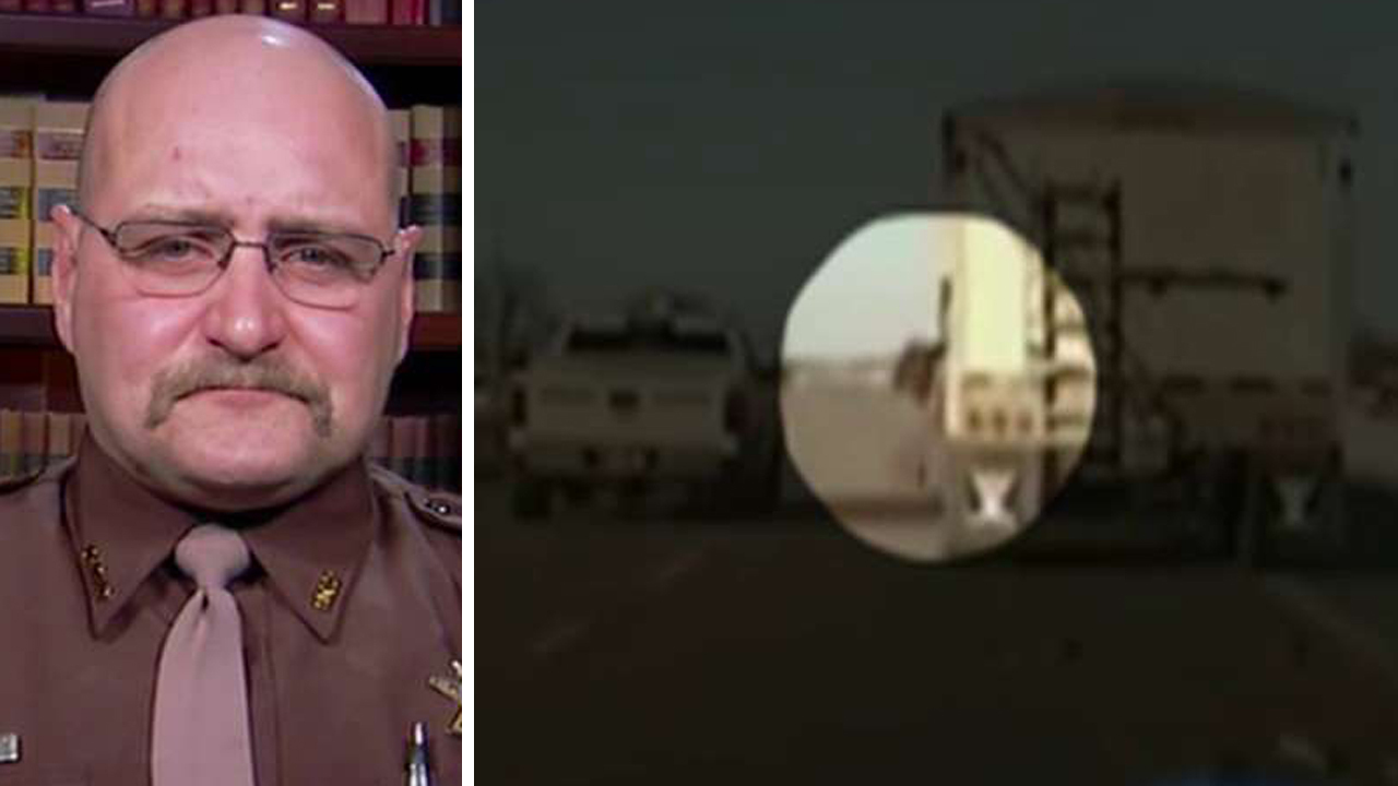 Cop jumps into moving truck to save driver