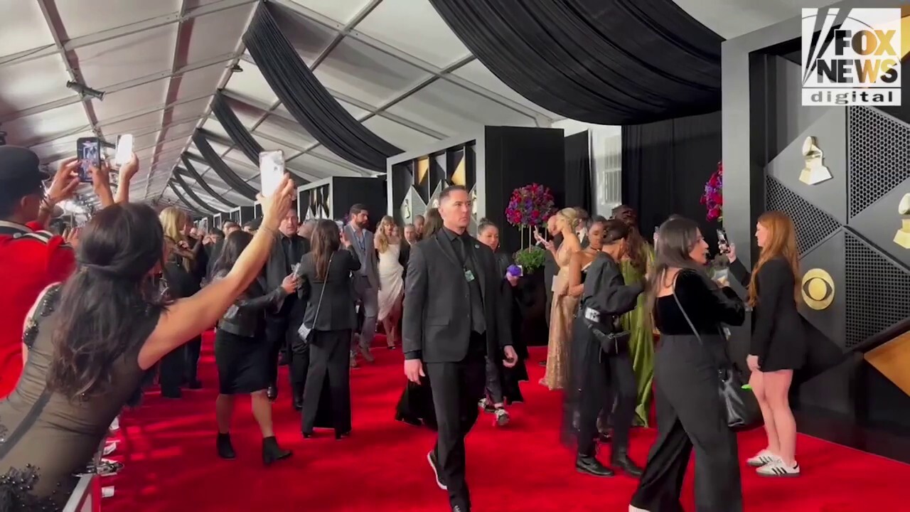 Taylor Swift walks the red carpet at the 2024 Grammy Awards