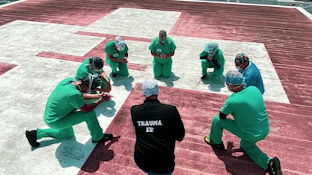 Nurses gather to pray on rooftops during COVID-19 pandemic