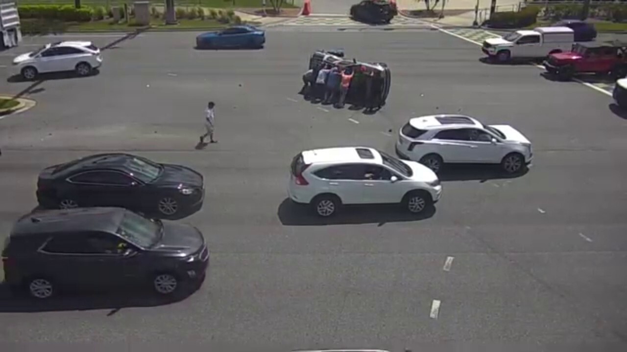 Bystanders flip overturned SUV upright on busy Florida boulevard