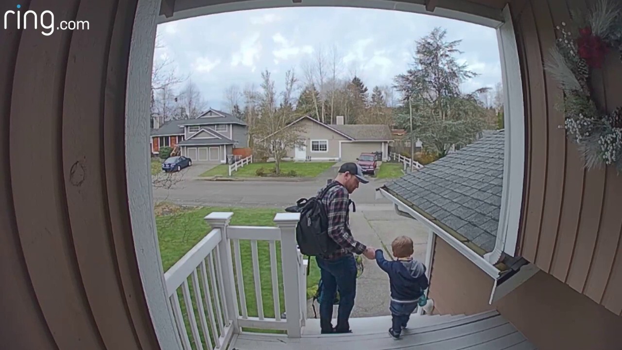 Young boy waves goodbye to mom as he leave for day care