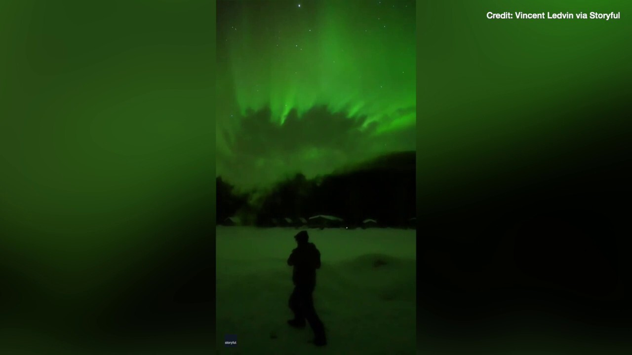 Watch as boiling water instantly freezes under bright green aurora in Alaska