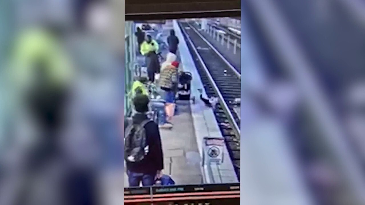 Woman shoves child onto train tracks