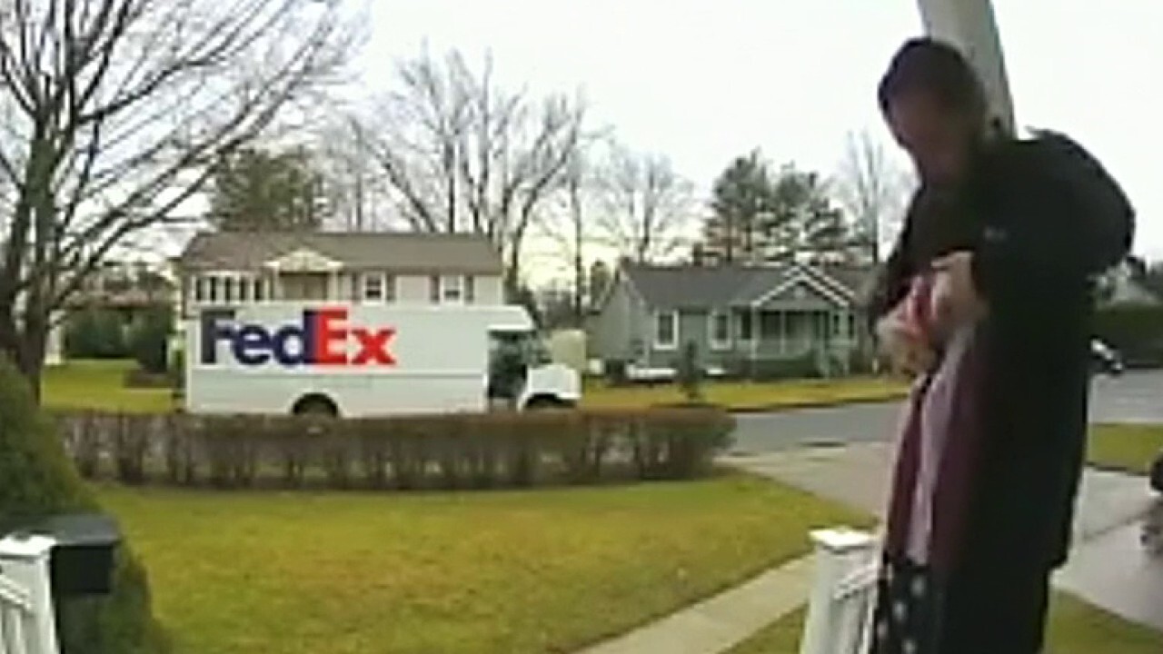 FedEx driver picks up, folds fallen American flag