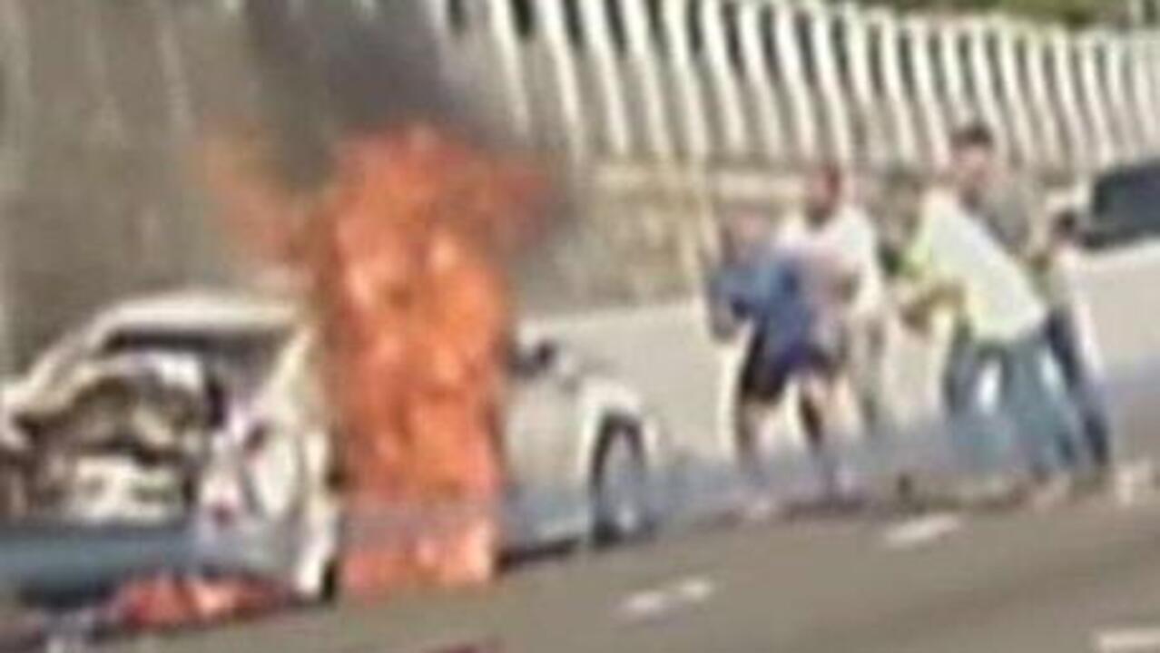 Woman pulled from burning car by total strangers