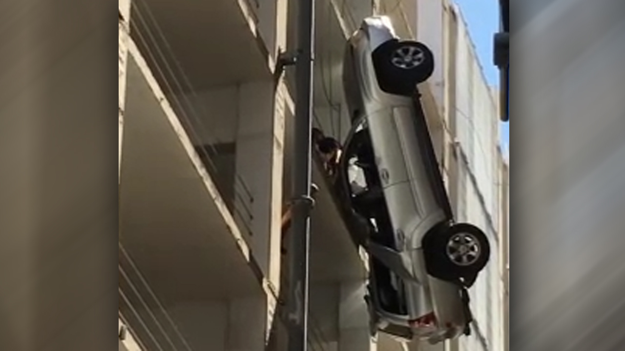 Driver escapes from dangling truck nine-stories above ground