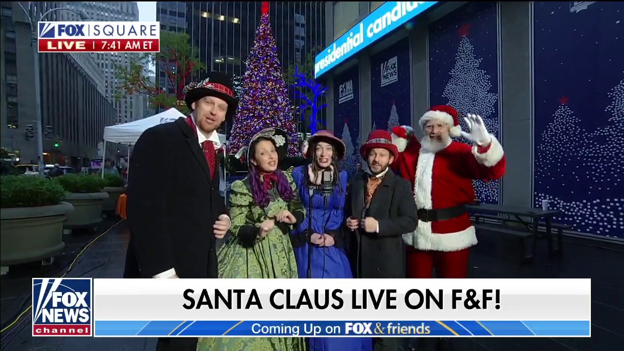 The Christmas Carolers perform 'Here Comes Santa Claus' on Fox Square