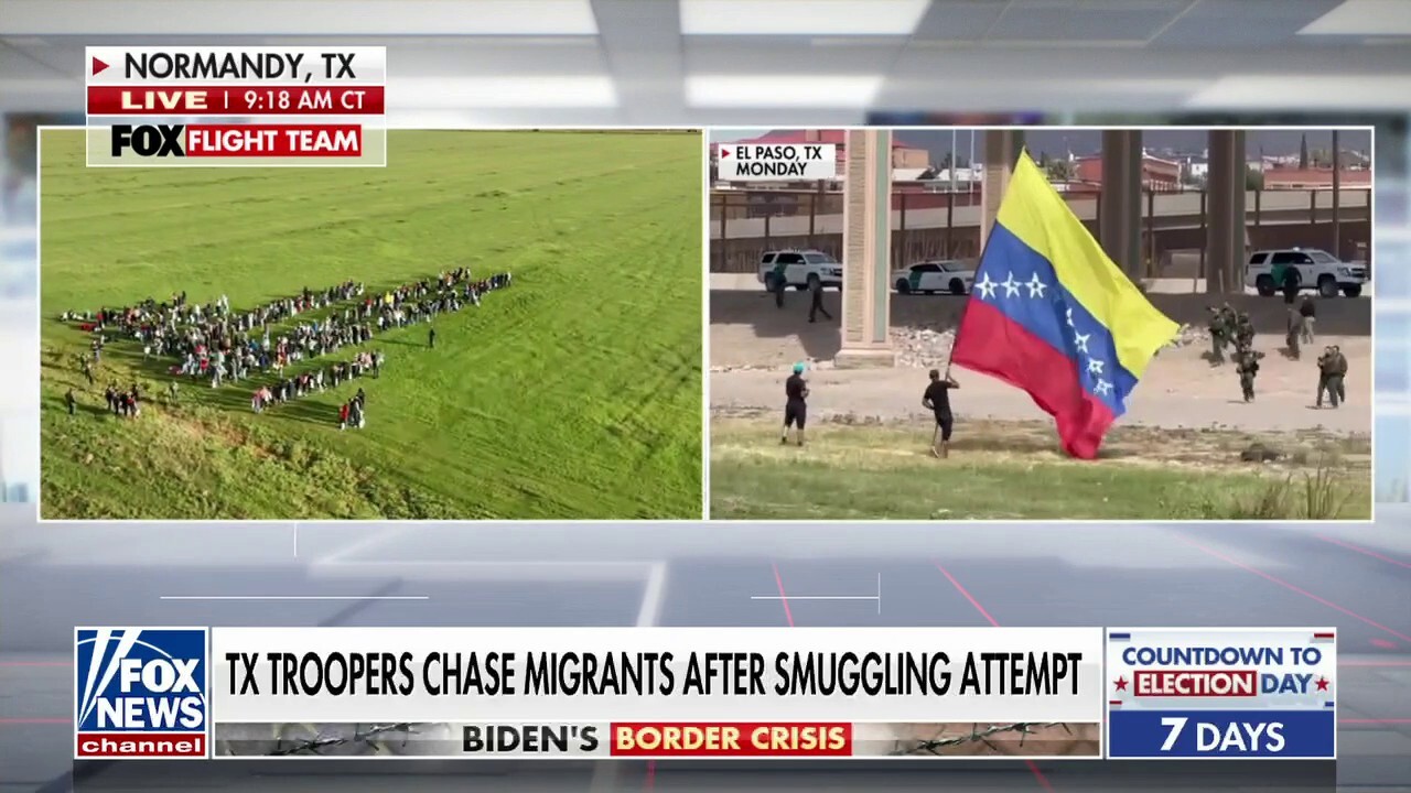 Massive group of Venezuelan migrants cross border, wave flag on US soil