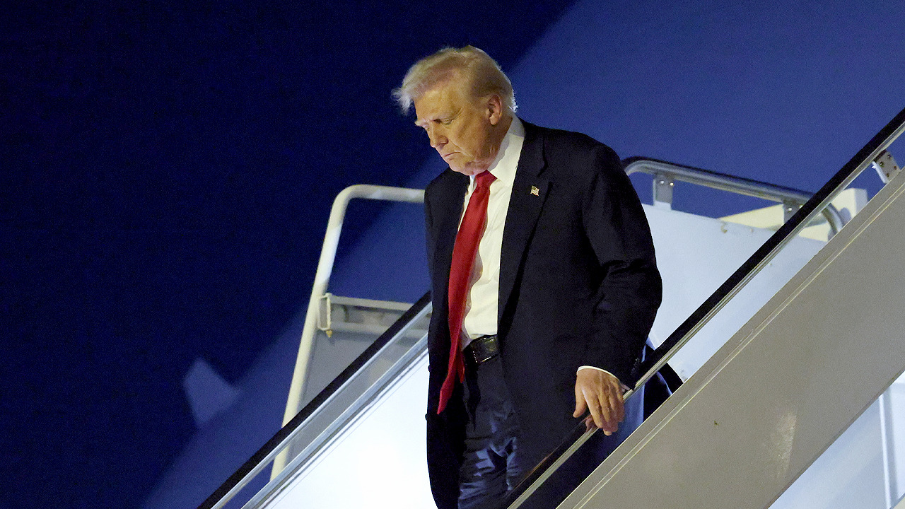  President Trump speaks to reporters aboard Air Force One