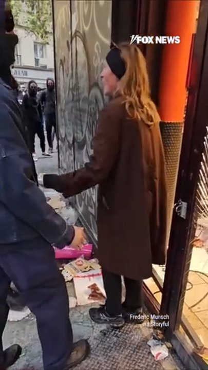 Woman blocks Paris supermarket entrance in attempt to stop looters