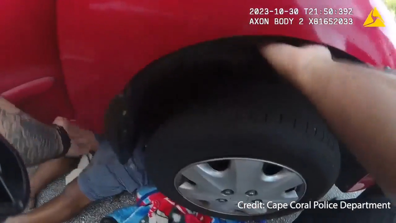 Florida police officers rush to aid of man stuck under car