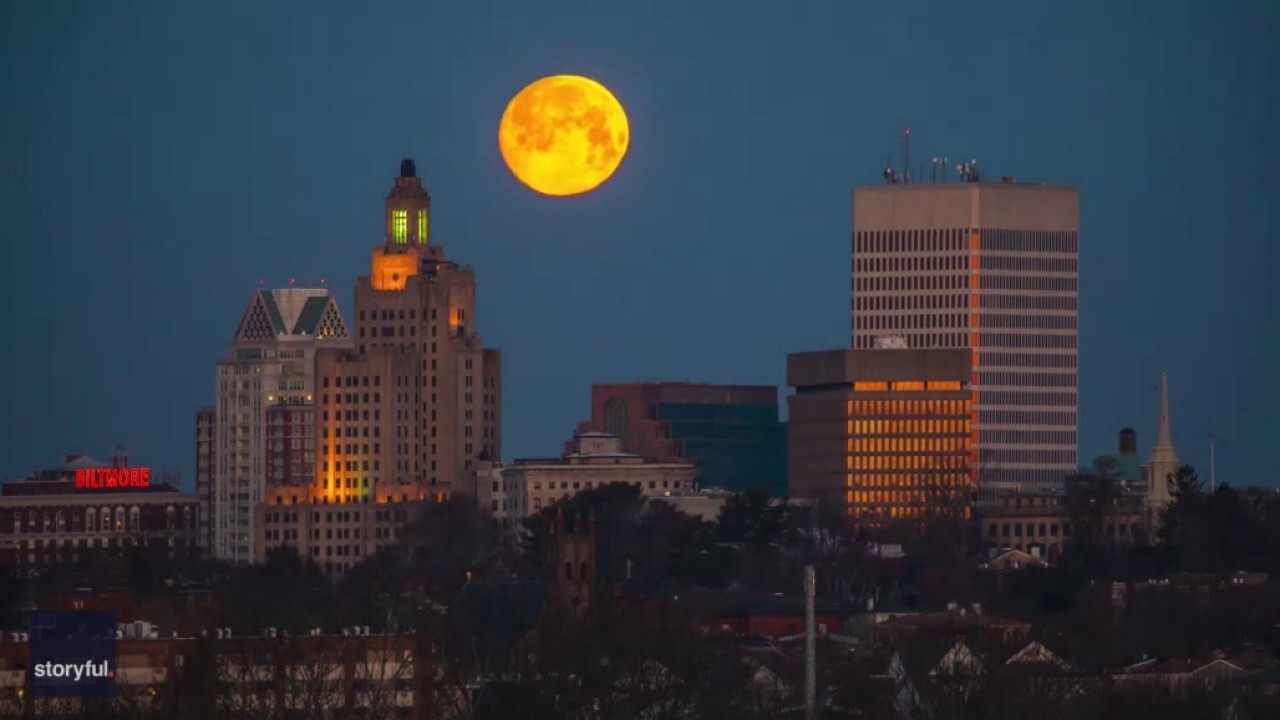 Orange moon sinks below Providence skyline in stunning timelapse footage