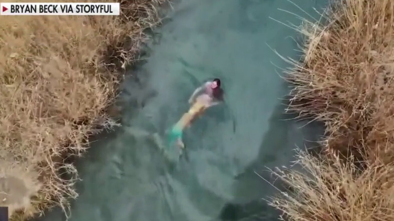 Drone footage shows woman in mermaid costume swimming