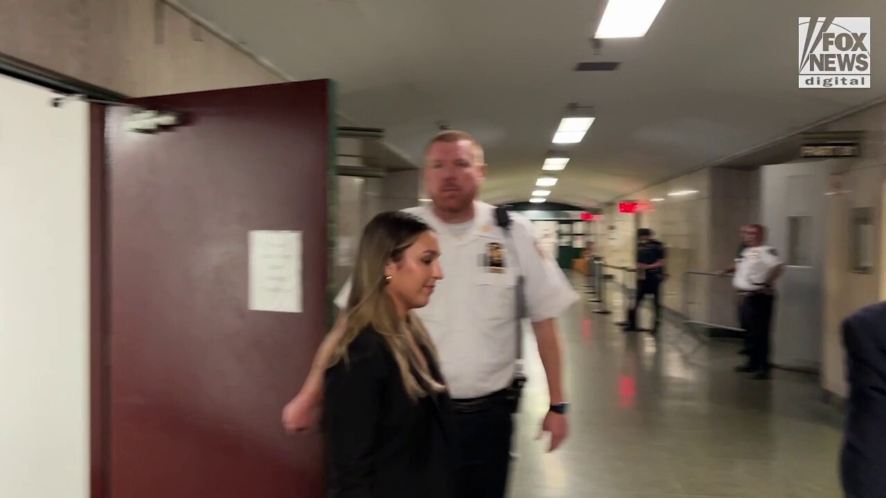 Jackie Penny walks in the hallway of Manhattan Supreme Court