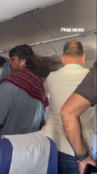 Flight forced to divert after overhead bin catches fire