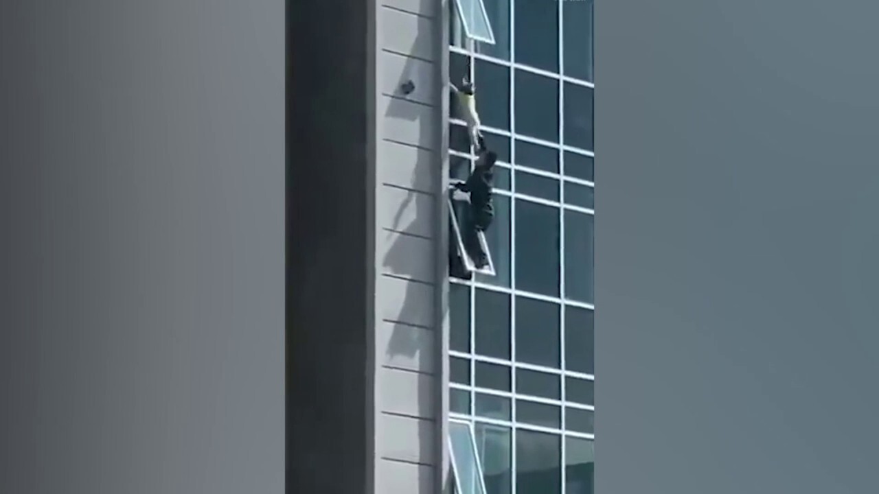 Heroic man saves boy hanging from a window in Kazakhstan