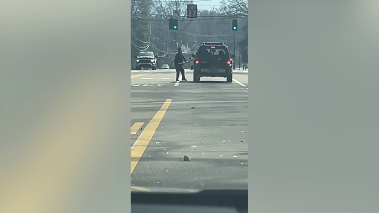 Suspect swings ax at car in apparent road rage incident