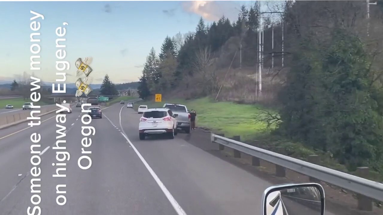 Drivers in Oregon stop to pick up hundred dollar bills on Interstate