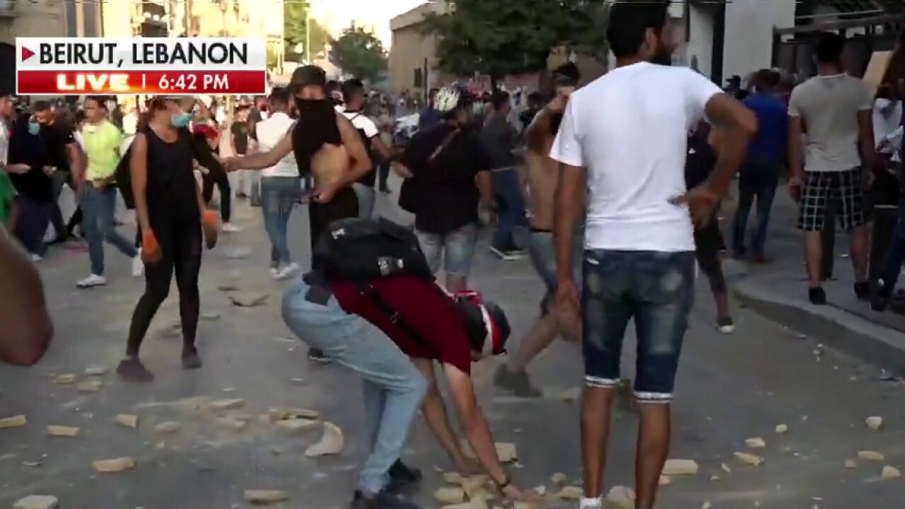 Lebanese protesters clash with police in Beirut after prime minister announces resignation