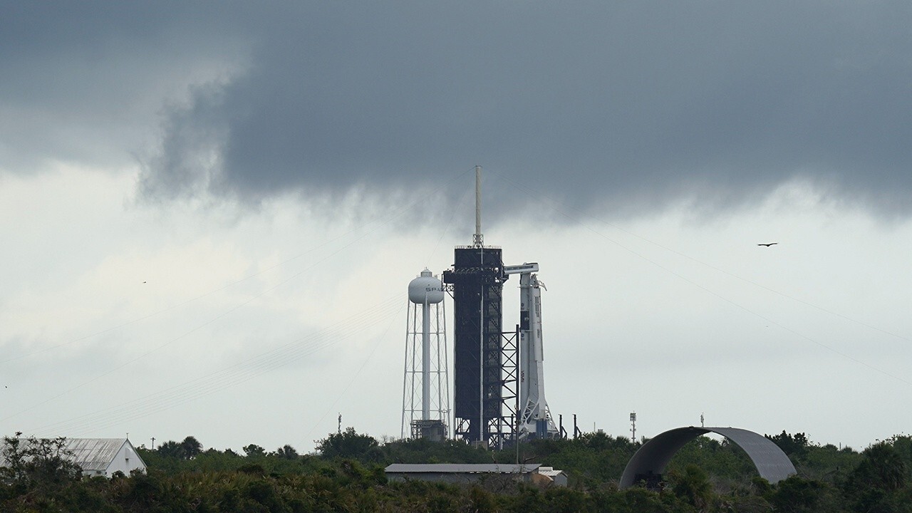 In face of 'launch fever,' NASA scrubs historic SpaceX flight attended by Trump due to weather