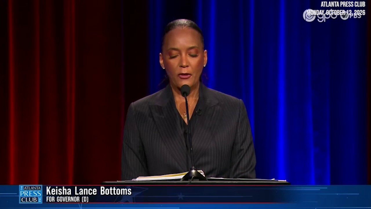 Georgia Democratic gubernatorial candidate stands next to empty podium as Republican opponent skips debate