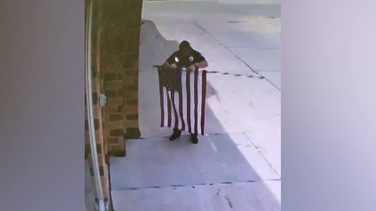 Nebraska officer seen fixing fallen US flag at auto repair shop