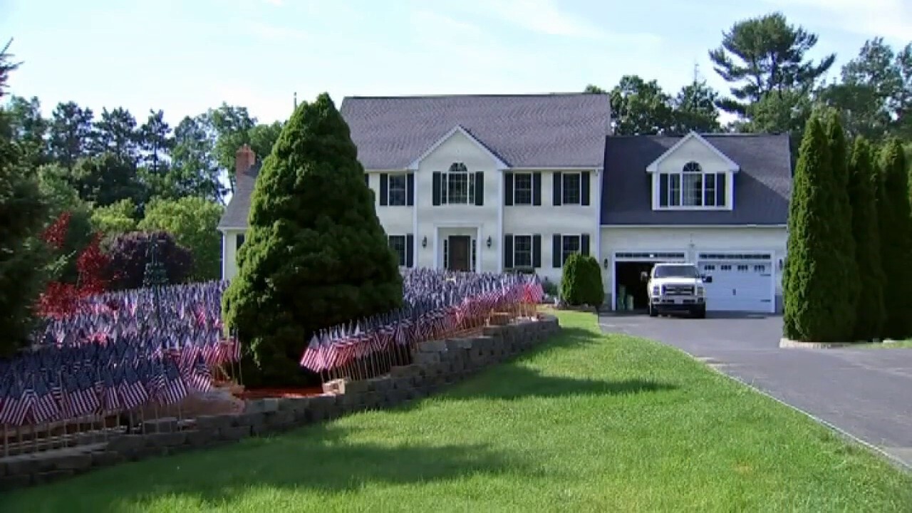 Flags at family home honors all Massachusetts COVID-19 deaths 