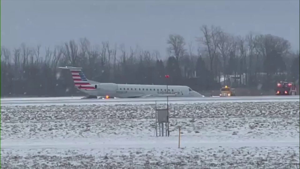 American Airlines plane slides of taxiway at New York airport amid snowy weather