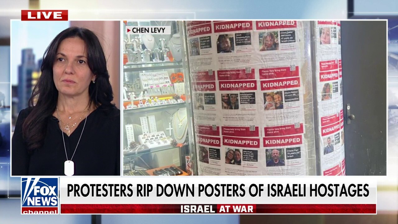 Protesters rip down posters of Israeli hostages