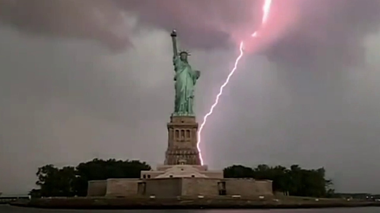 Lightning strikes behind the Statue of Liberty	