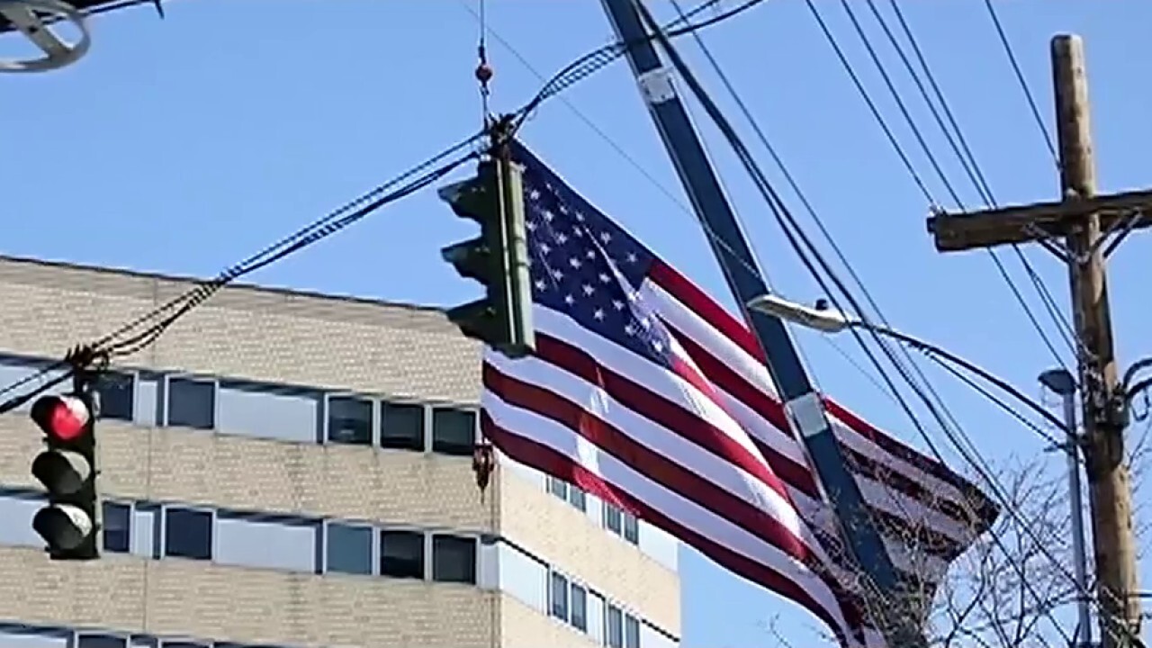 Tree service hangs giant US flag, 'thank you' sign at hospitals during coronavirus crisis