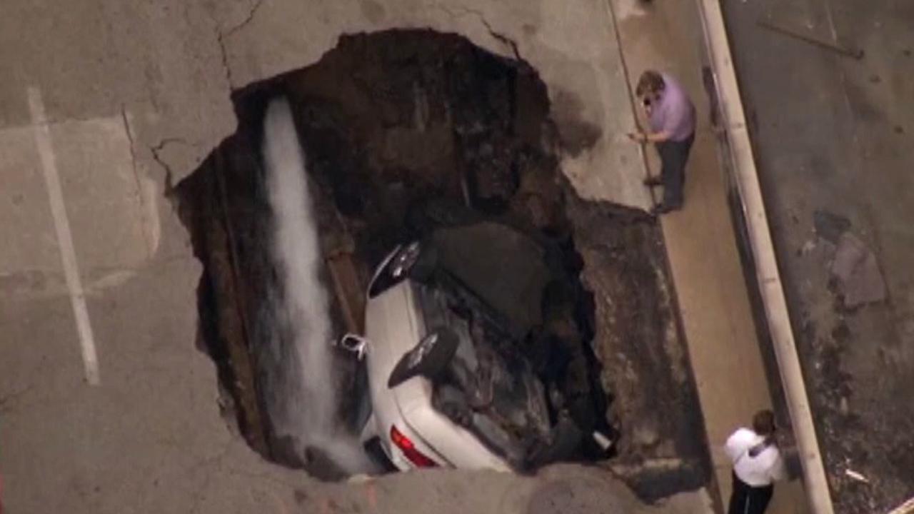 Large sinkhole opens up, swallows car