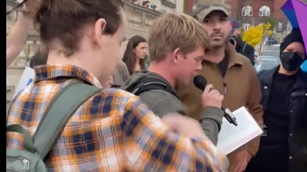 Leftist protesters harass man reciting Bible verses, take Bible and rip up pages, protester eats pages