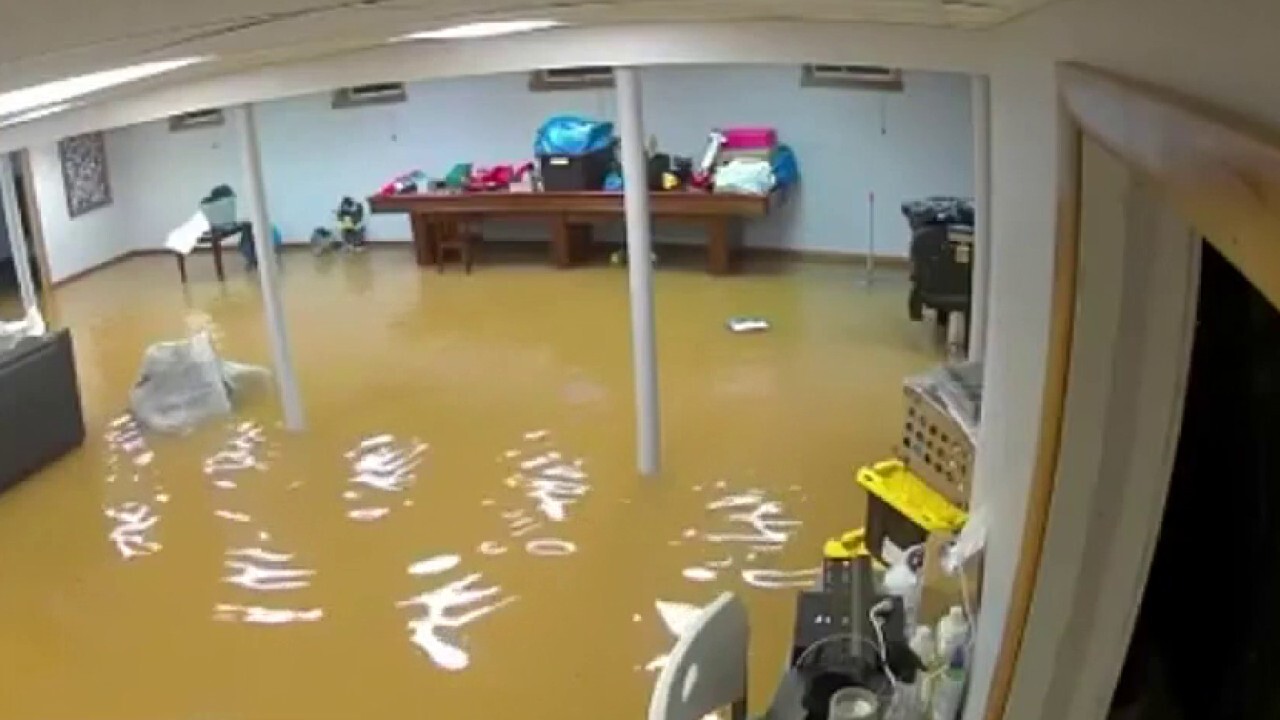 Dramatic footage captures floodwaters rushing into home after wall collapses