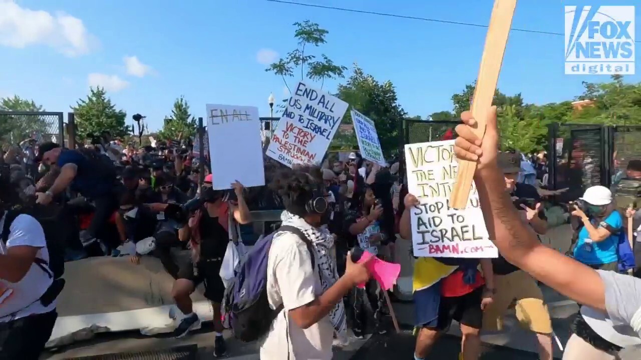 Pro-Hamas demonstrators breach a fence outside of the DNC on Monday