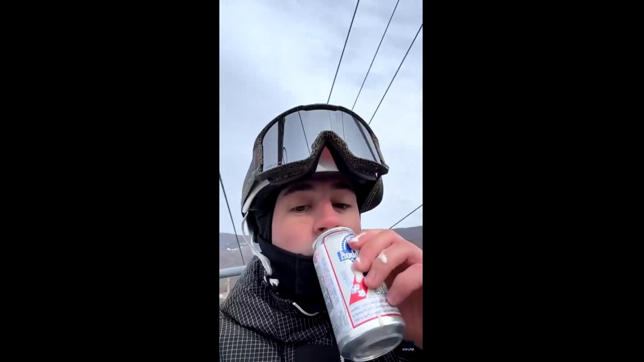 Snowboarder makes impressive beer catch on chairlift