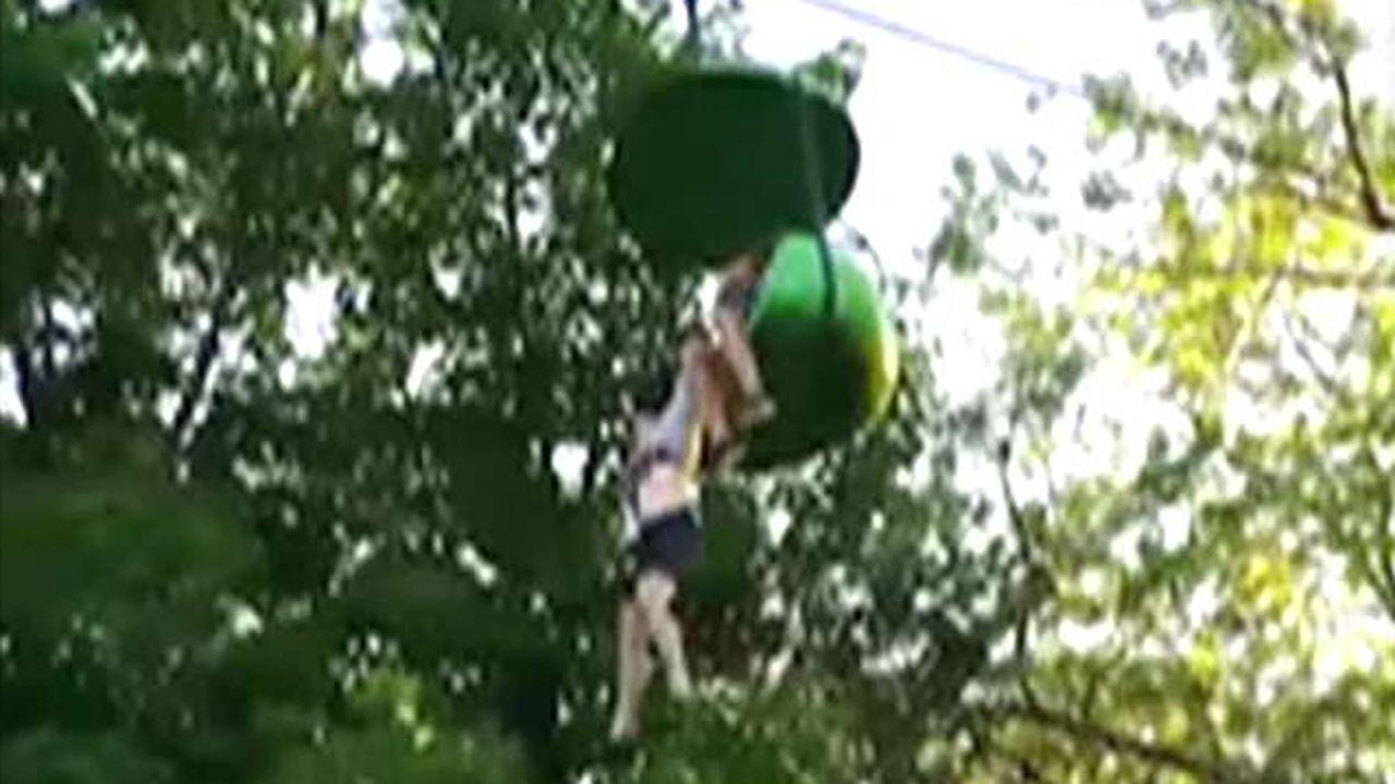Crowd catches girl falling from amusement park ride