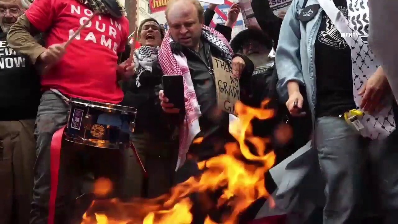 Columbia University students rip up, burn diplomas after graduating