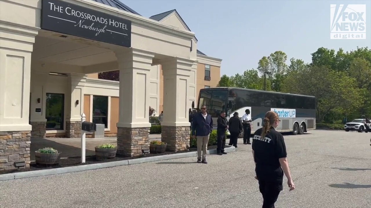 Migrants arrive by bus at The Crossroads Hotel in Newburgh, NY