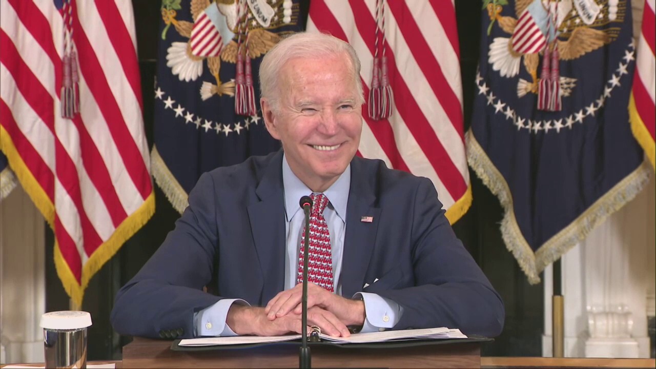 Biden laughs at question on "politically divisive" Trump indictment
