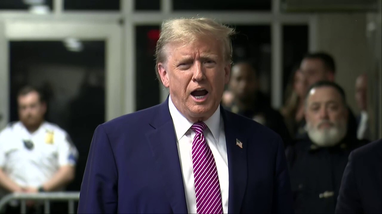 Former President Donald Trump speaks to reporters outside the courtroom Friday