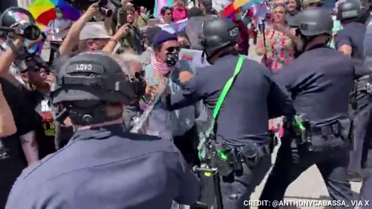 Police clash in downtown LA with backers of Calif. school policy to hide gender identity from parents