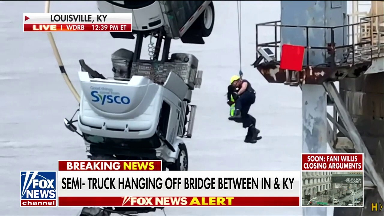 Semi-truck hangs off a Kentucky bridge, rescuers save driver