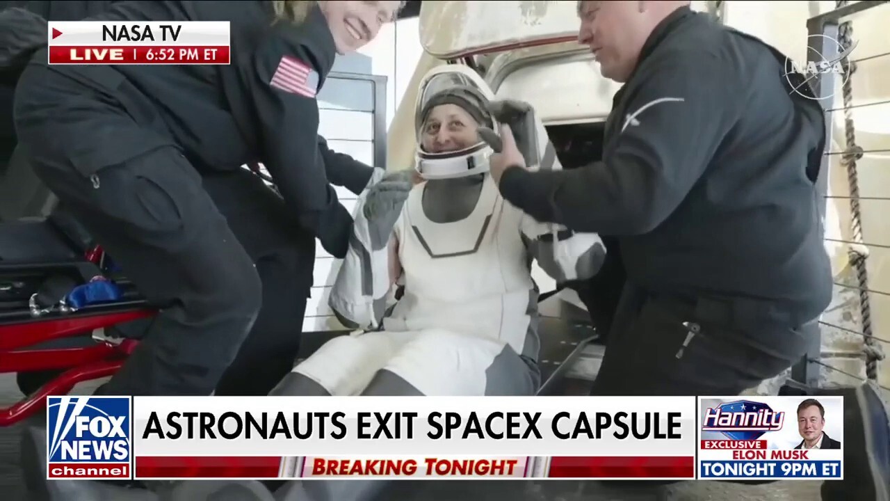 Astronauts exit Dragon capsule after return to earth