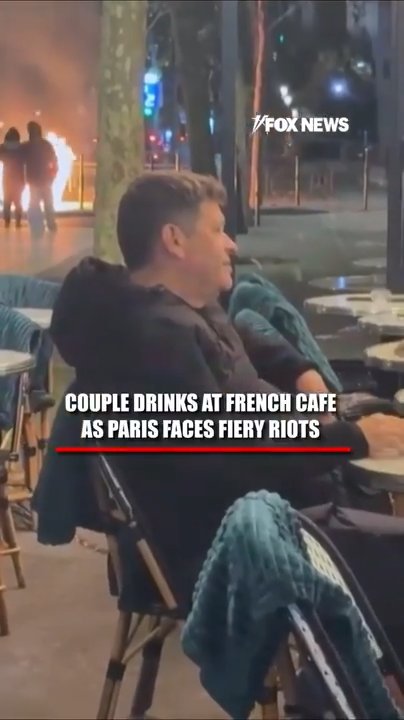 Couple drinks at French cafe amid fiery riots
