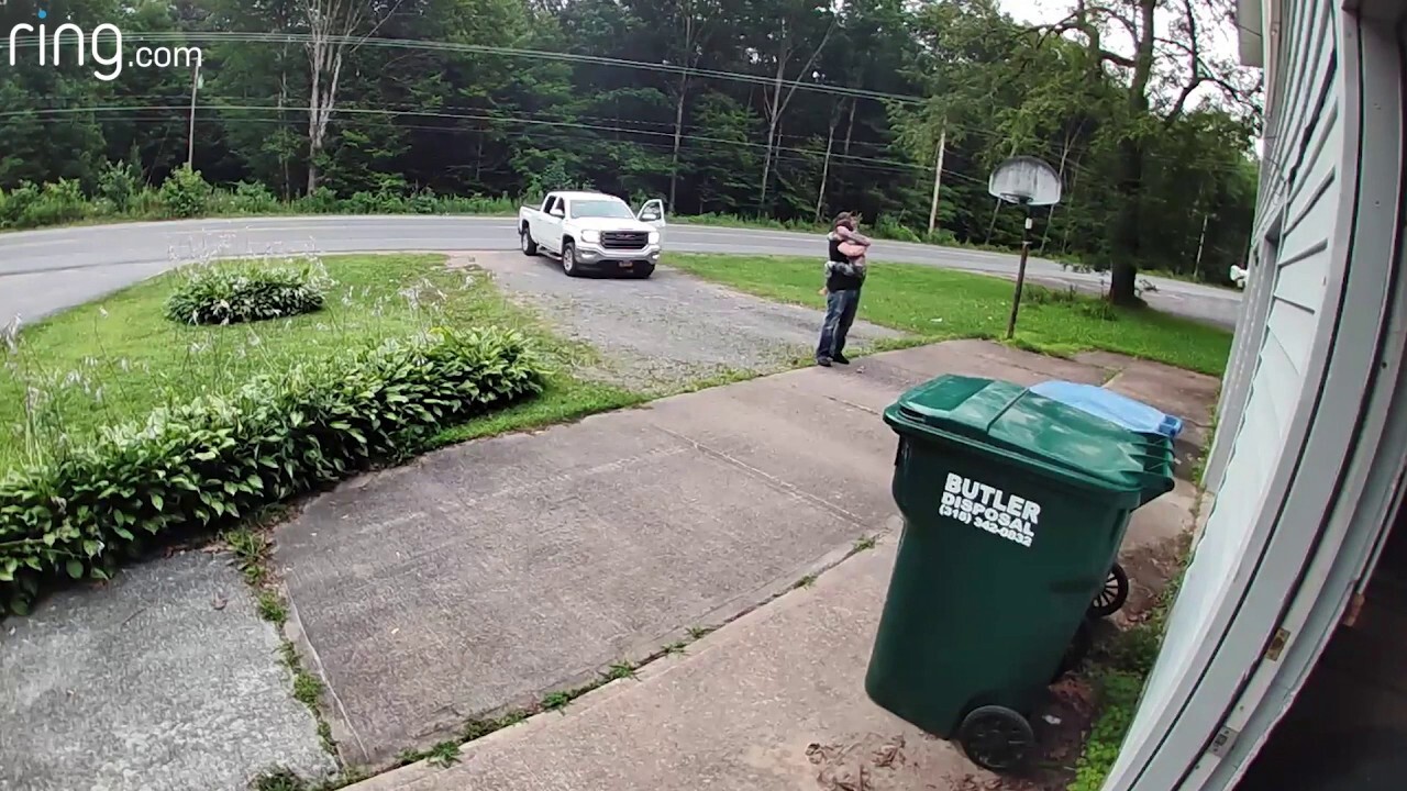 Young boy runs after his dad to give him a hug before he leaves for work