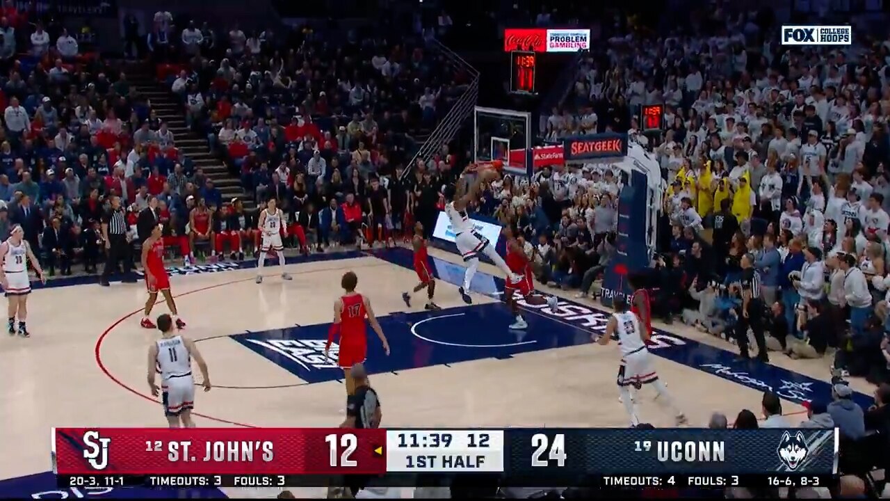 Tarris Reed slams down a two-handed jam, extending UConn's lead over St. Johns