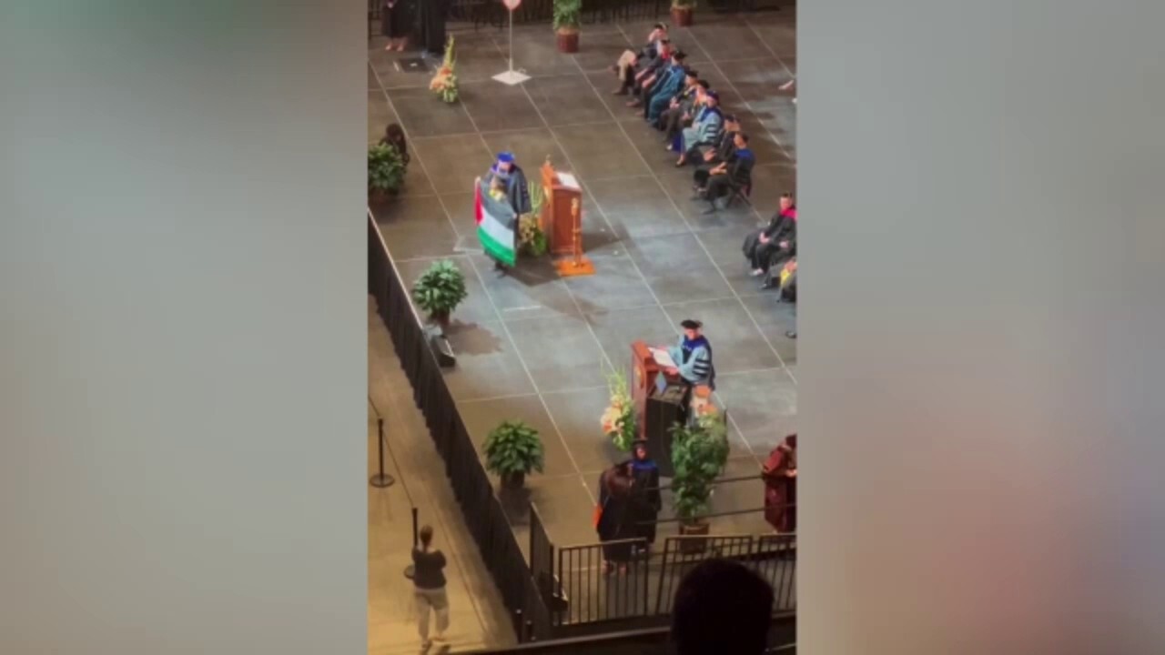 Student holds up Palestinian flag during UT Austin commencement ceremony